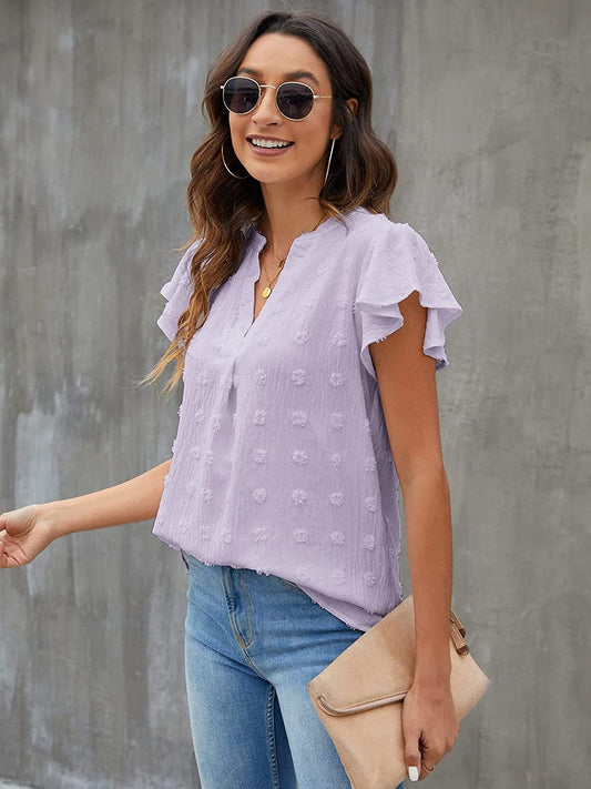 Blusa con mangas acampanadas y muescas con lunares suizos